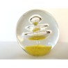 SPHERICAL GLASS PAPERWEIGHT:  YELLOW FLOWER WITH SMALL BUBBLES AND BIG CENTRAL SPIRAL